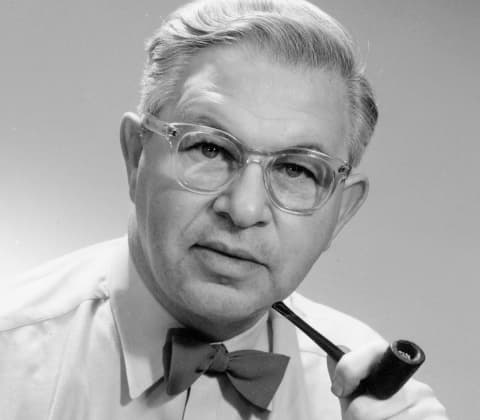 A portrait of Arne Jacobsen holding a tobacco pipe