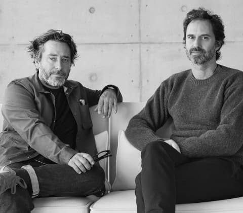 A portrait of Edward Barber and Jay Osgerby sitting on a sofa